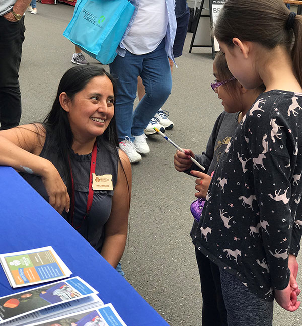 Master Recycler talking with children at event