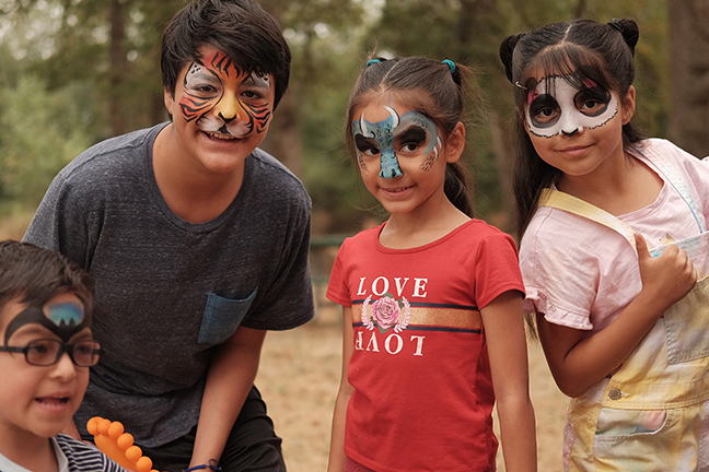 Four children enjoy last year's FIesta Latina event at a park
