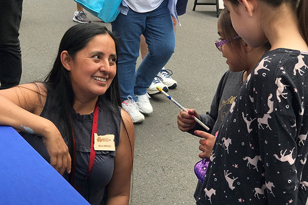 Master Recycler talking with children at event