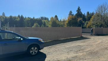 Car in front of fence