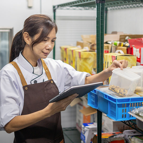 Worker inspecting food in pantry