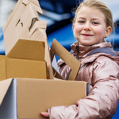 Girl with cardboard to put in recycling