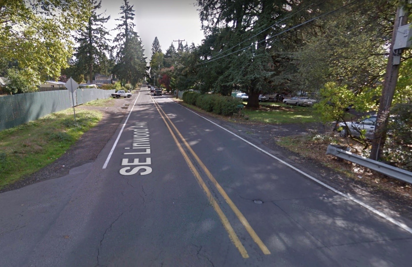 A typical section of SE Linwood in 2020 with no bike paths or sidewalks