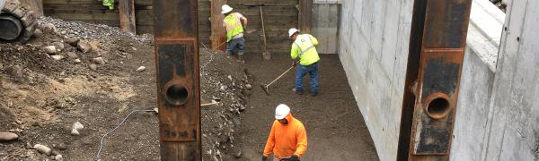 Three workers repairing the bridge