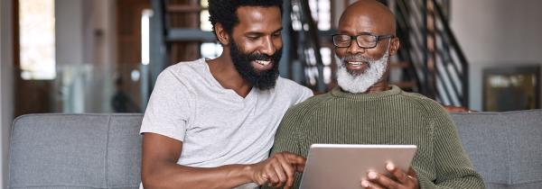 men taking survey on couch with ipad