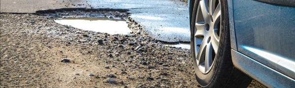 Car approaching a pothole