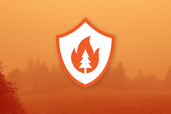 Wildfire preparedness symbol: a tree of fire within a shield