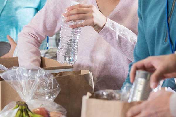people packing boxes with food and water