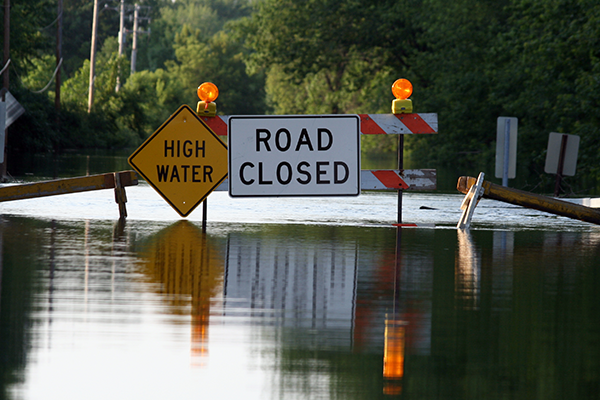 Flooded street with a Road Closed sign