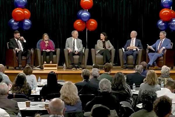 Commissioners seated on a stage discussing the direction of the county