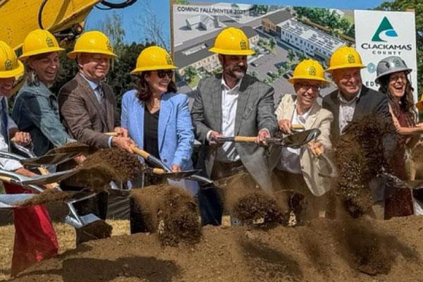 Commissioners and other dignitaries breaking ground on new construction site
