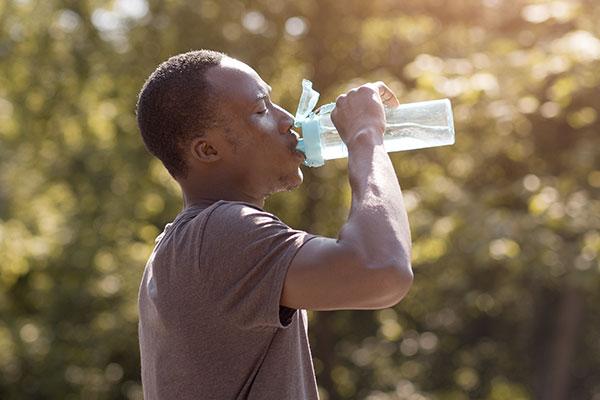 Man drinking water on a hot day