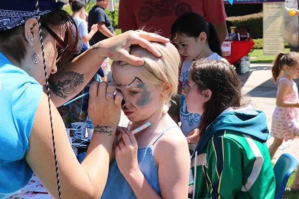 child getting face painting