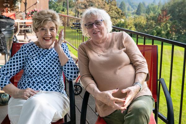 Senior Companion Program volunteer Ellen Morgan (right) provides companionship and reading support to client Trevalee Johansson.
