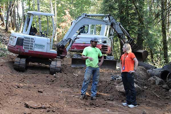 man and women working on stormwater repairs