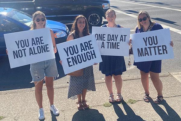 County staff holding signs of hope