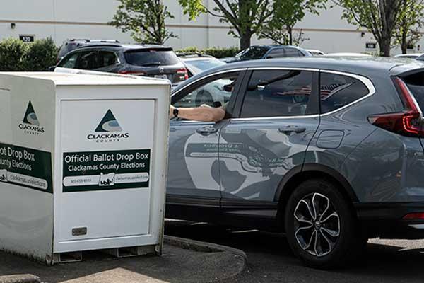 Dropping off ballots at a drop box