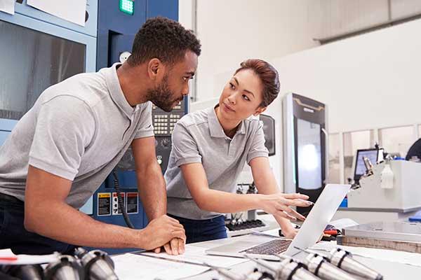 people talking and pointing at a computer
