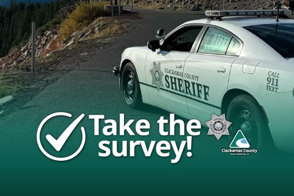 Sheriff's vehicle on mountain road with the text "Take the survey!" and Clackamas County and Clackamas County Sheriff logos