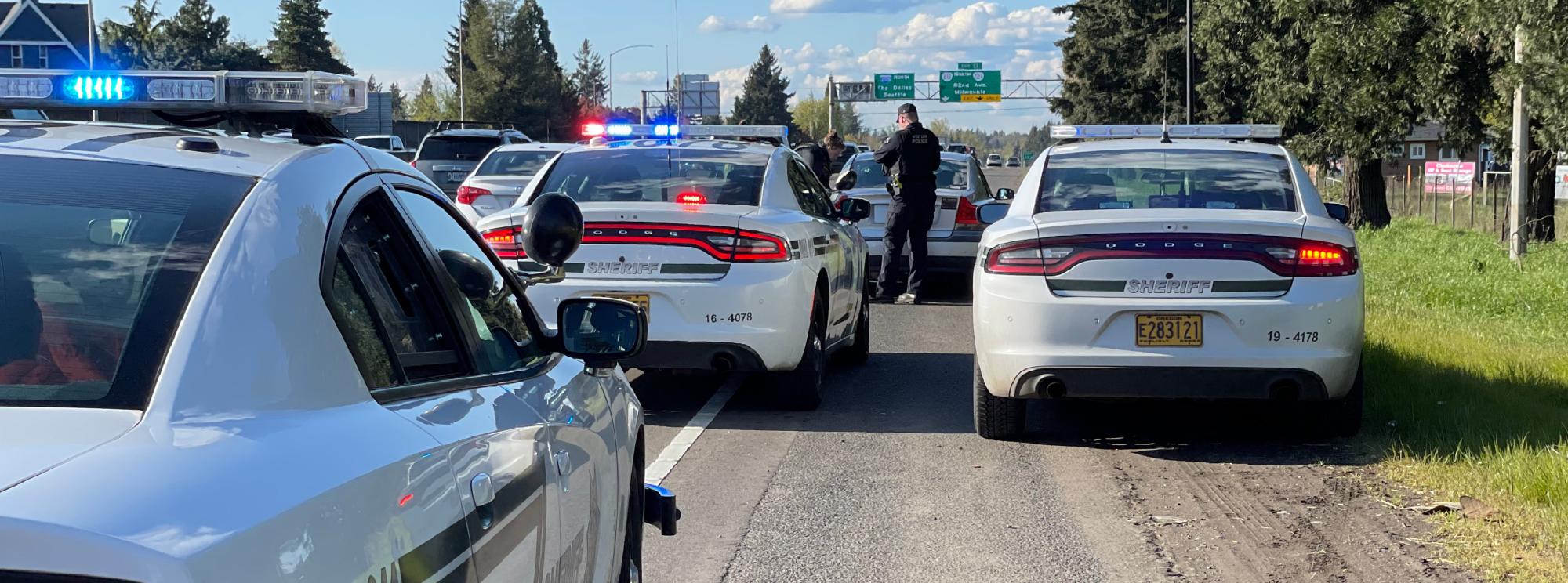 3 Clackamas County Sheriff vehicles pulled to the side of the freeway
