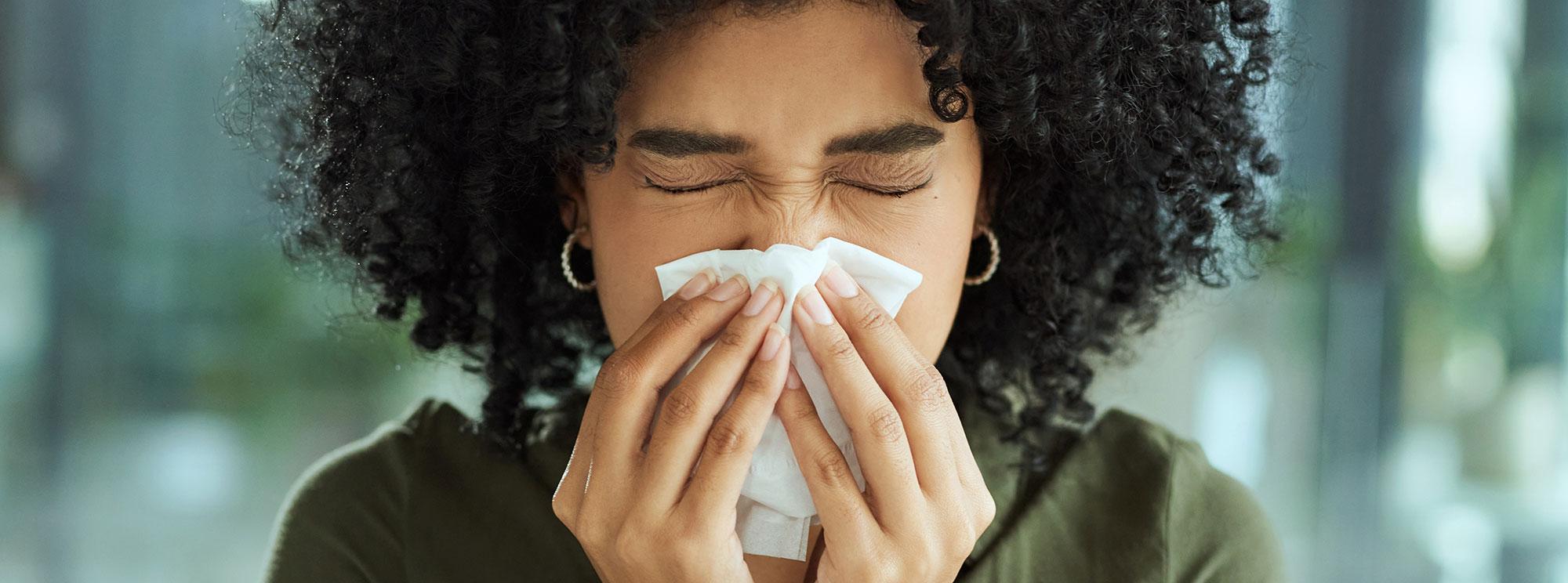 Woman blowing her nose