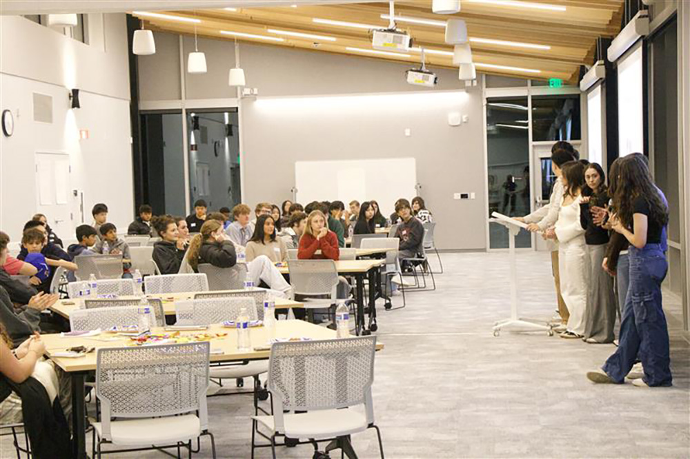 Teenagers listening to speakers