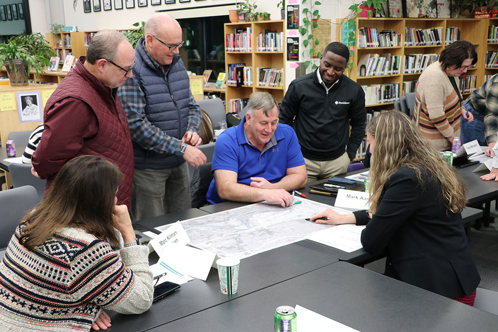 Steering Committee looking at a map