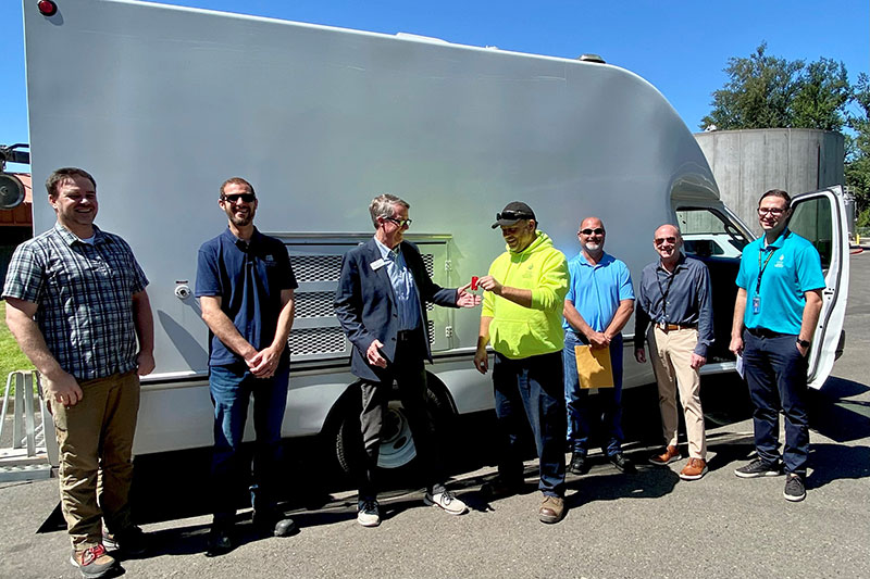Mayor Michael Milch, Public Works Director Darren Caniparoli, and Utility Manager Justin Poyser from Gladstone receive the CCTV truck from WES Director Greg Geist, Field Operations Supervisor Kyle Bean, Operations Manager Matt House and Sanitary and Stormwater Technician Kevin Rotrock.