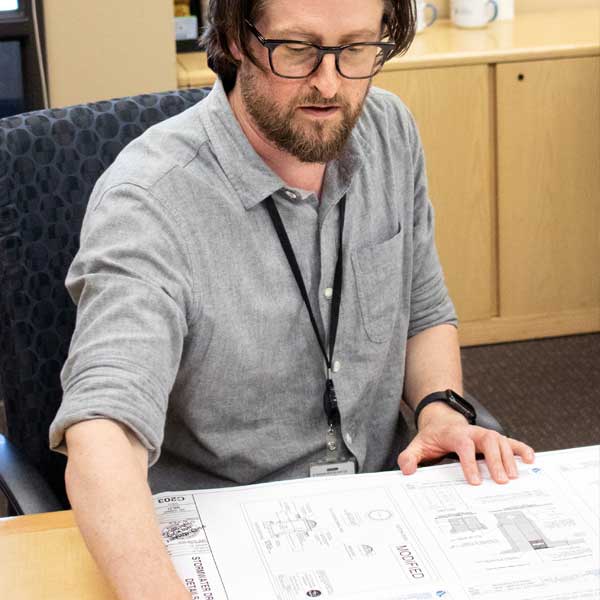 Man in office reviews plans