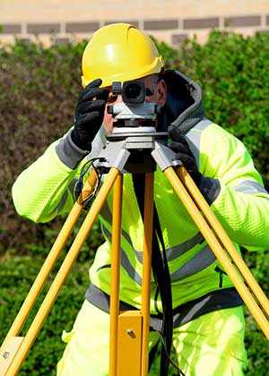 Man in construction gear surveying