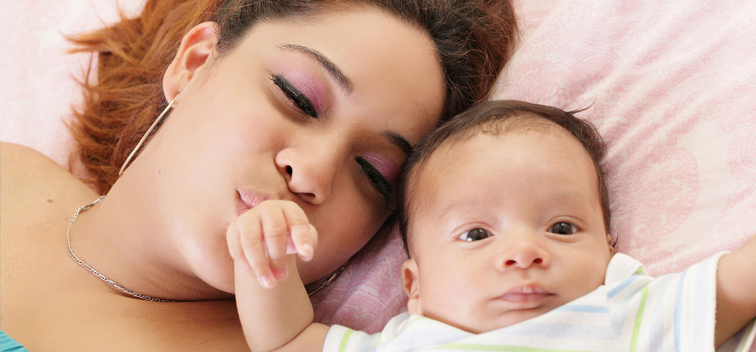 Mother kissing her baby's head